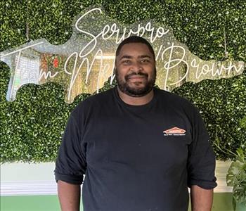 Young man standing with a Servpro shirt on